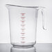 A Choice clear plastic measuring cup with red graduations and a red handle.