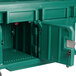 A green plastic storage box with doors on wheels.