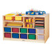 A Jonti-Craft wooden storage island with colored bins on a wood surface.