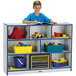 A boy reading a book on a blue and gray Rainbow Accents storage cabinet.