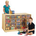 A young boy and girl play with colorful toys stored in a Jonti-Craft wood storage island with clear trays.
