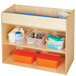 A Young Time natural wooden changing table with orange plastic containers on a shelf.