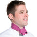 A man in a chef's uniform wearing a mauve Intedge chef neckerchief.