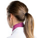 A woman wearing a mauve Intedge chef neckerchief with a ponytail.
