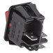 A black Estella Caffe power switch with red lights.
