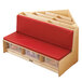 A wooden corner bench with red cushions and storage.
