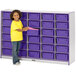 A young girl standing next to a Rainbow Accents purple and gray laminate storage cabinet with purple storage bins.