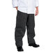 A person wearing Chef Revival black and white striped chef pants.