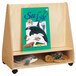 A Jonti-Craft mobile wood pick-a-book stand with sea life and a whale book cover on a shelf with stuffed animals.
