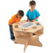 Two children playing with a Jonti-Craft science activity table with cubbies.