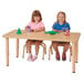 Two children sitting at a Jonti-Craft rectangle table with toys.
