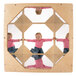A baby sitting in a Jonti-Craft wood cube with an acrylic mirror.