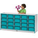 A child stands in front of a Rainbow Accents teal and gray storage cabinet with teal tubs.