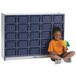 A young girl sitting next to a Rainbow Accents navy laminate storage cabinet with navy trays.