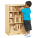 A boy playing with a Jonti-Craft wood block storage cabinet.