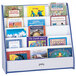 A Rainbow Accents blue book rack with many books on it.