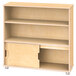 A Jonti-Craft natural wooden bookcase with two shelves and a sliding door.