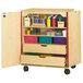 A Jonti-Craft wooden mobile classroom supply cabinet with shelves and compartments.