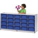 A child standing in front of a Rainbow Accents blue and white storage cabinet filled with blue tubs.
