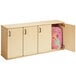 A Young Time natural wooden classroom locker with a pink backpack inside.