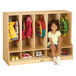 A little girl sitting on a Jonti-Craft toddler-height coat locker.