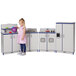 A little girl playing with a blue and white Rainbow Accents kitchen set.
