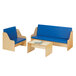 A natural wooden Young Time living room set with blue padded seating including a couch and table.