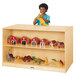 A boy stands behind a Jonti-Craft wood storage island with toys.