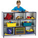 A boy reading a book on a Rainbow Accents mobile storage cabinet.