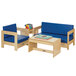 A Jonti-Craft children's wood living room set with blue cushions on a blue couch next to a table with books.