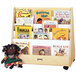 A Jonti-Craft wooden rack with books and a doll.