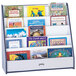 A navy Rainbow Accents book rack with many books on it.