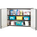 A Rainbow Accents black laminate wall-mount storage cabinet with a black and white rectangular object with items on it.