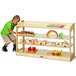 A young boy playing with a Jonti-Craft wooden toy shelf.