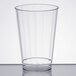 A WNA Comet clear plastic fluted tumbler on a white surface.