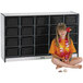 A young girl sitting in front of a Rainbow Accents black laminate storage cabinet with black trays.