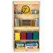 A Jonti-Craft wooden storage cabinet with books on the shelves.