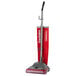 A red Sanitaire TRADITION upright vacuum cleaner with a handle.