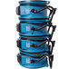 An XPOWER commercial shop fan with blue and black buckets stacked in front of it.