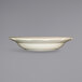 A white stoneware bowl with a wavy edge.