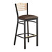 A Lancaster Table & Seating black bistro bar stool with dark brown vinyl seat and natural wood back.