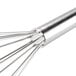 A Thunder Group stainless steel piano whisk with a metal handle.