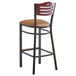A Lancaster Table & Seating bistro bar stool with a brown vinyl seat and mahogany back on a black frame.