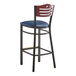 A Lancaster Table & Seating black bistro bar stool with a navy vinyl seat and mahogany wood back.