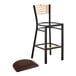 A Lancaster Table & Seating black bistro bar stool with a dark brown vinyl seat and natural wood back.