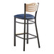 A Lancaster Table & Seating bistro bar stool with a navy seat and natural wood back on a black frame.
