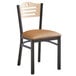 A Lancaster Table & Seating black bistro chair with a natural wood seat and tan cushion.