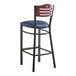 A Lancaster Table & Seating Bistro bar stool with navy vinyl seat and mahogany wood back on a black frame.