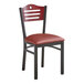 A Lancaster Table & Seating black metal bistro chair with a burgundy vinyl seat.