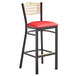 A Lancaster Table & Seating black bistro bar stool with a red vinyl seat.